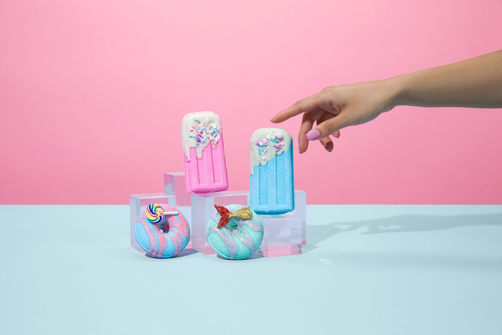 A vibrant display of assorted handmade bath bombs and natural skincare products from The Lavish Goat collection. A vibrant display of assorted handmade bath bombs and natural skincare products from The Lavish Goat collection.